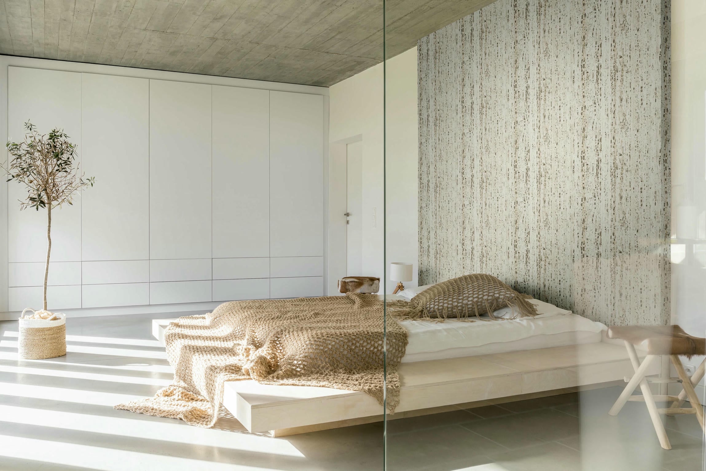 Light bedroom with king size bed and white wardrobe