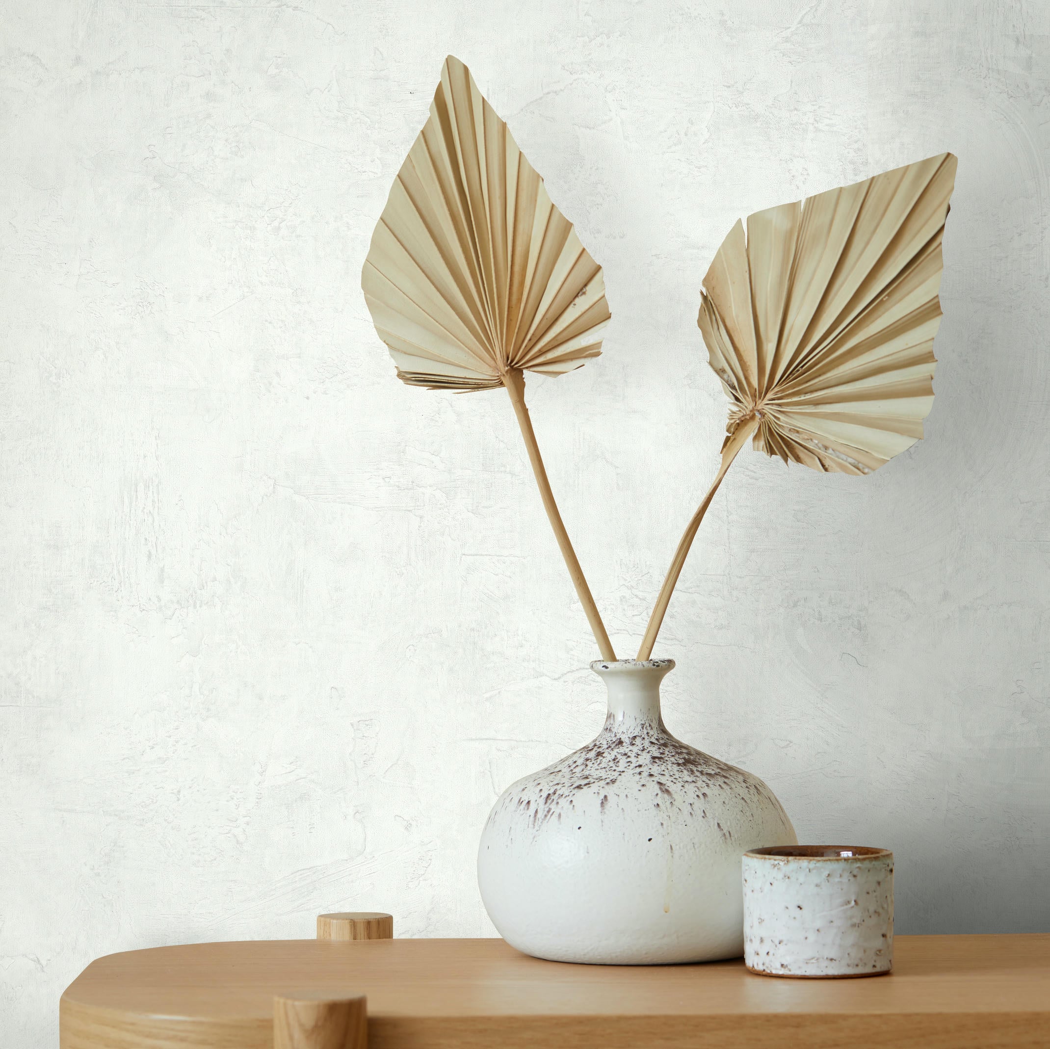 Wabi sabi interior of living room with wooden console, paper flowers in vase, accessories and copy space. Minimalistic concept. Template.; Shutterstock ID 1996820057; purchase_order: -; job: -; client: -; other: -