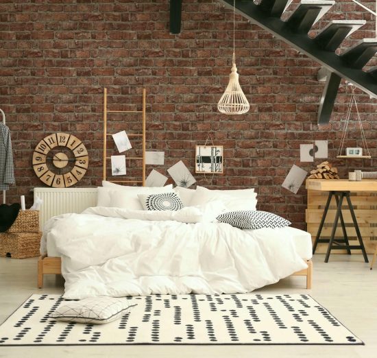 Elegant interior of bedroom with workplace under stairs